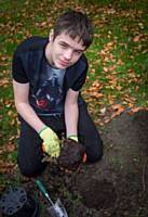 Redwood Student Volunteer planting around the Old Beech Tree